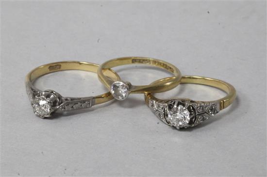 Three 18ct gold and diamond rings,